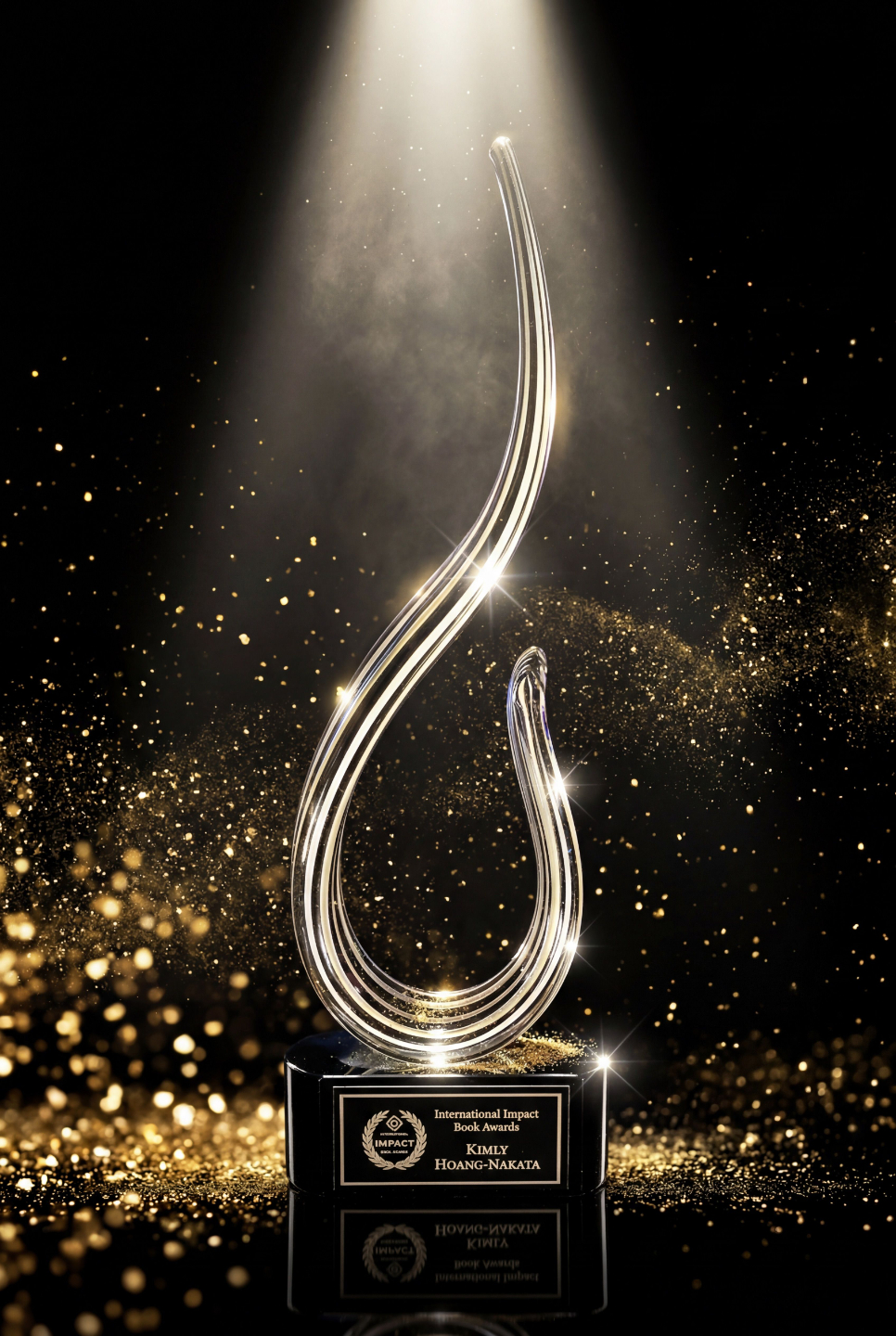 Kimly Hoang-Nakata's engraved International Impact Book Awards glass trophy, spotlit in gold dust