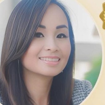 Kimly Hoang-Nakata smiling in a professional portrait