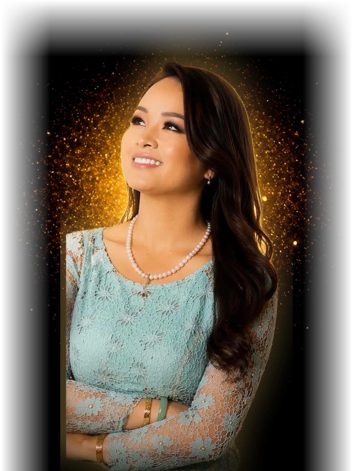 Kimly Hoang-Nakata in a teal lace dress, looking up toward golden light